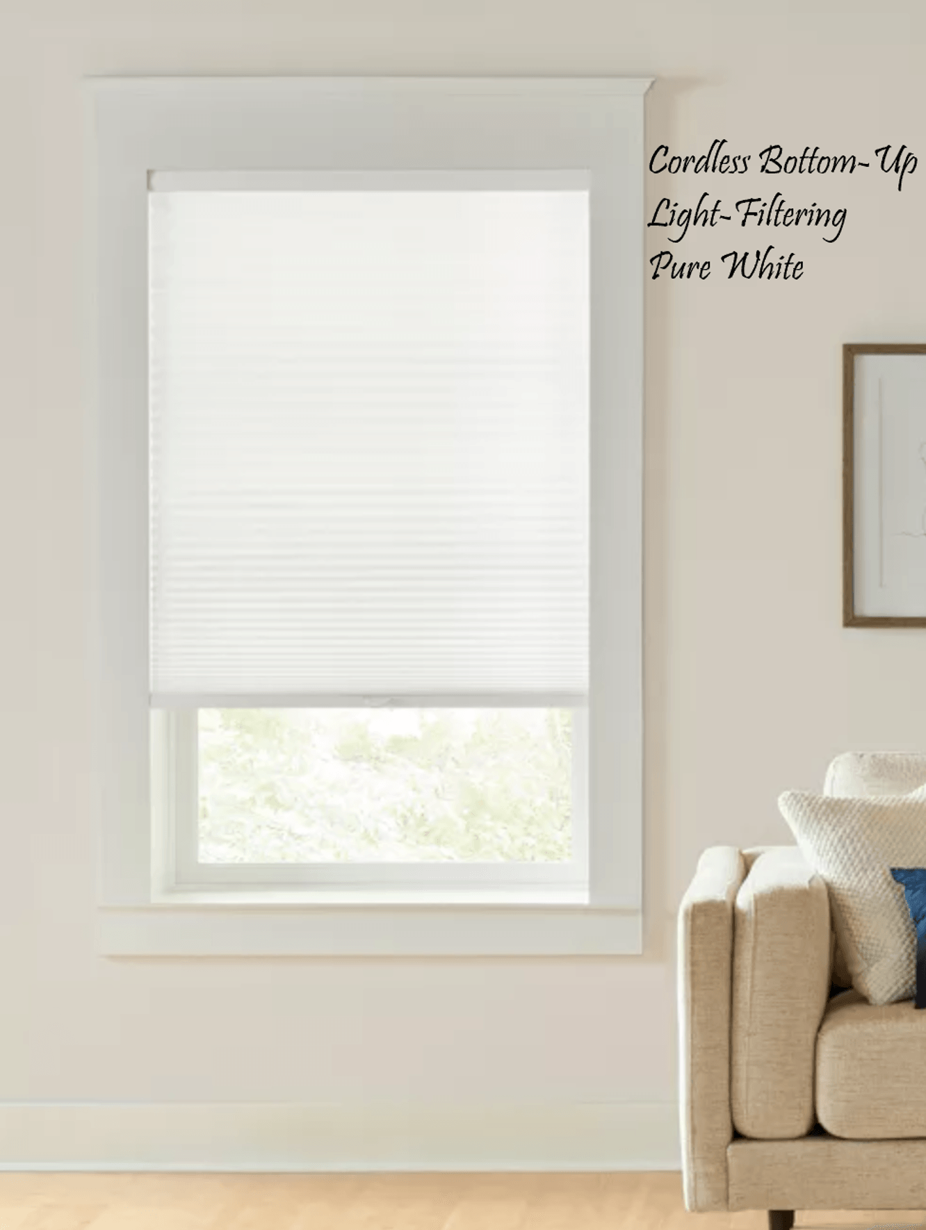 White cellular shade in a window, partially covering it. Beige couch in the corner.