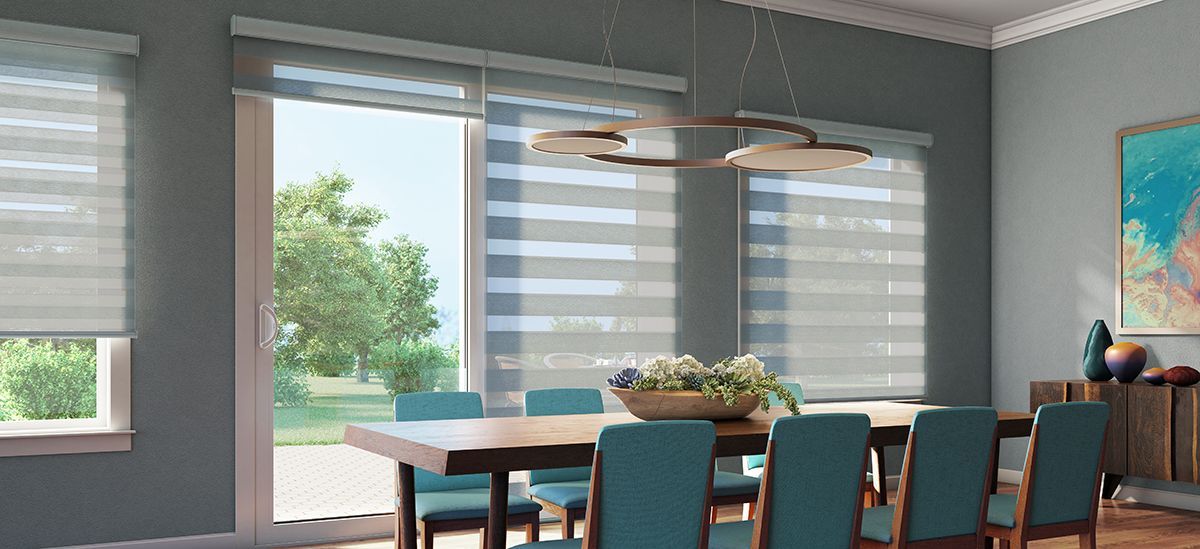 A dining room with a table, chairs, artwork, and window blinds. Teal accents on the chairs and art.