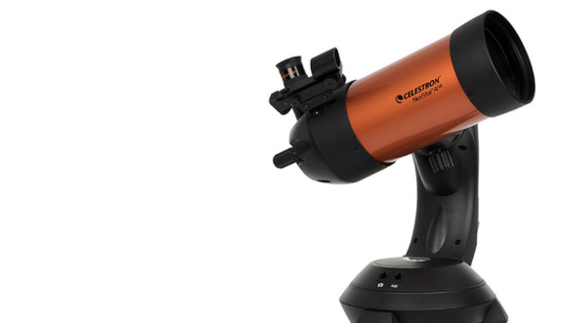 Orange and black telescope on a black base, angled upward.