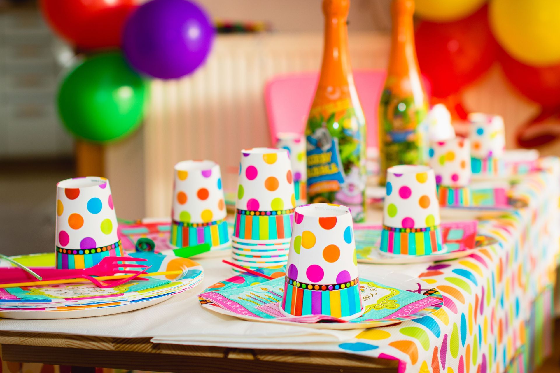 Colorful polka-dot party table with cupcakes, balloons, and bright decorations