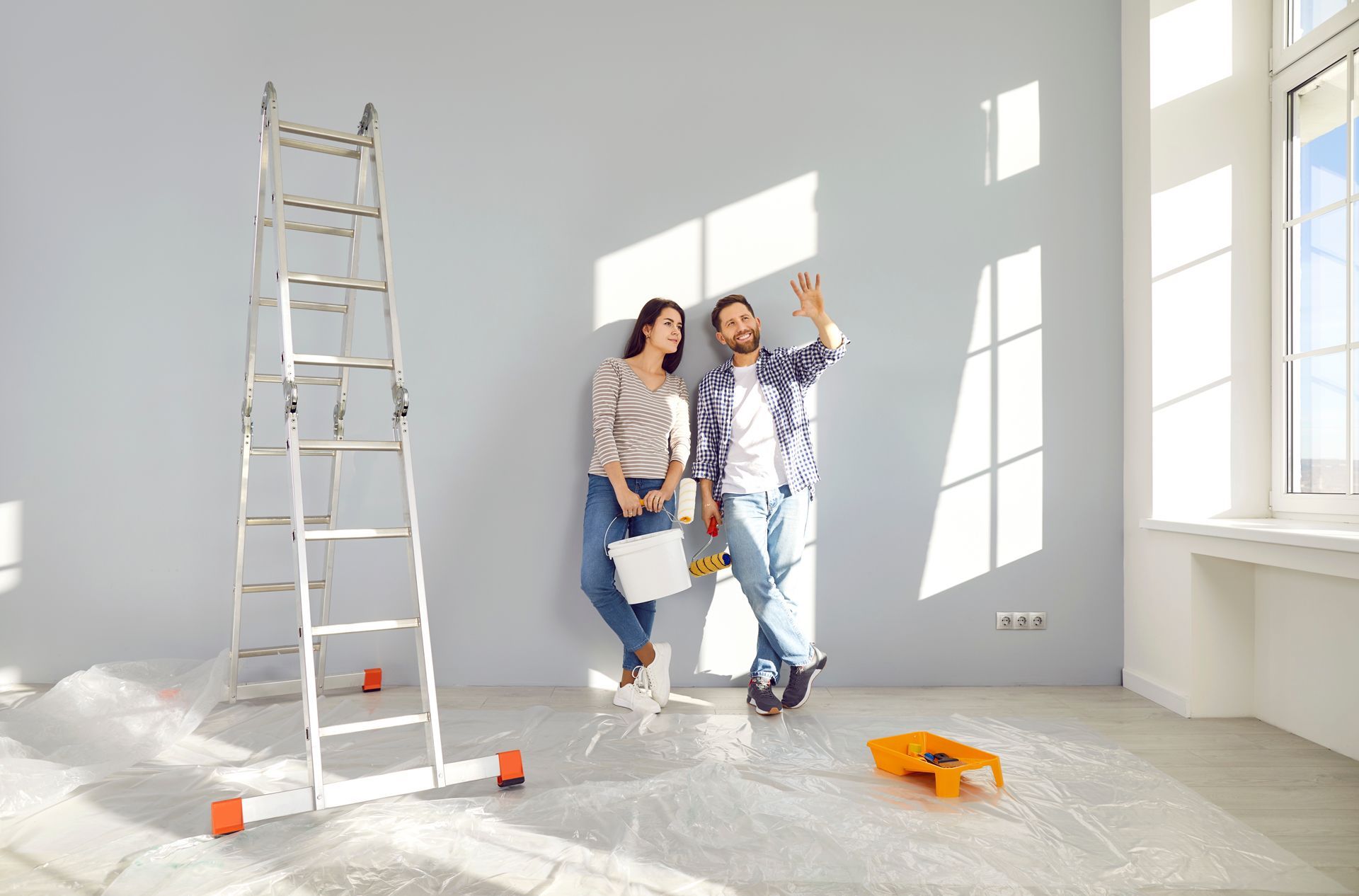 Couple in room, prepping for painting