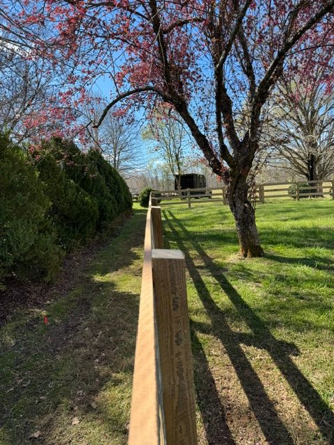 A wooden fence is surrounded by trees and grass in a park — Scottsville, Va — Pbr Grounds Llc