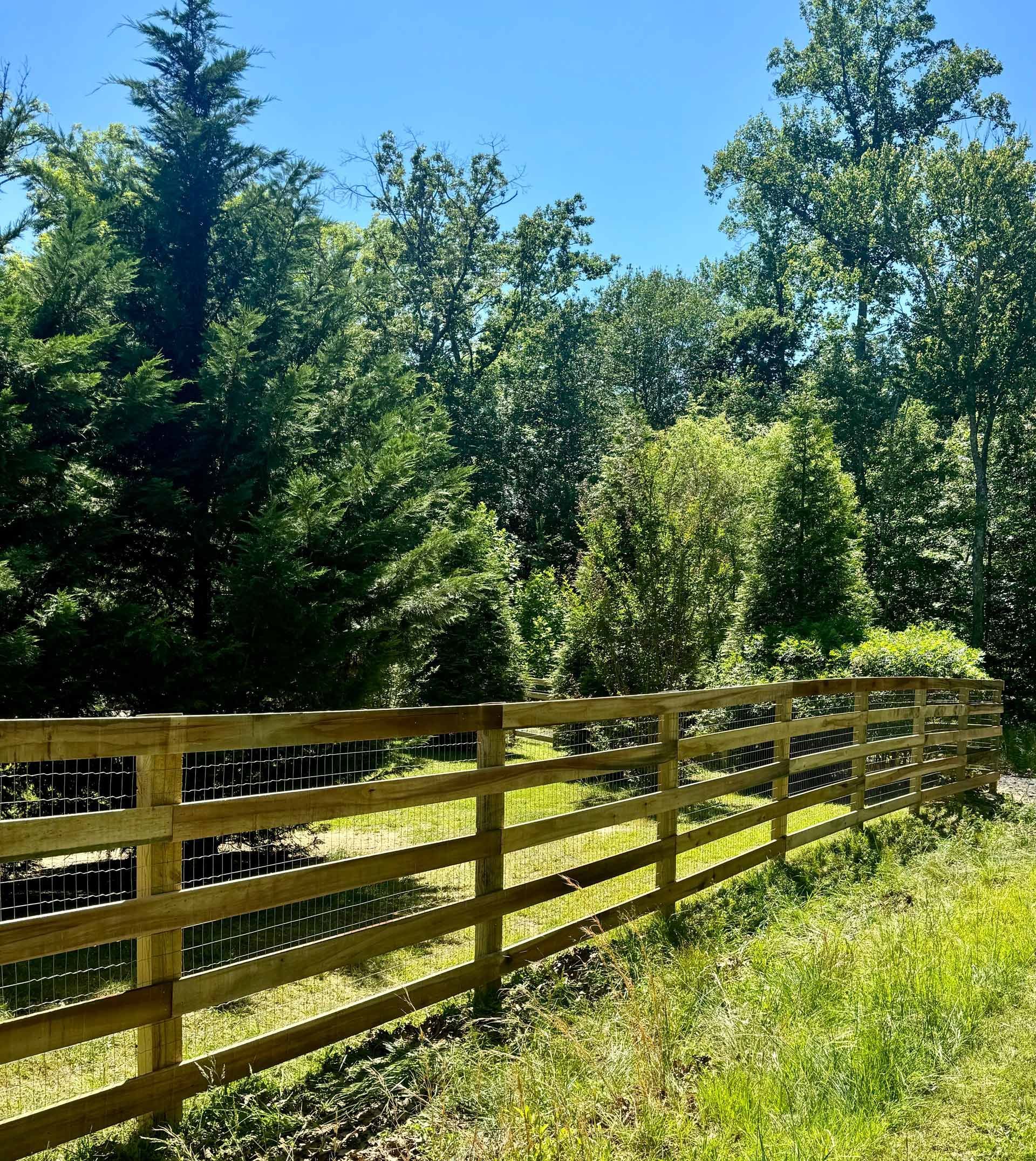 Wooden Fence Surrounds A Grassy Field In The Middle Of A Forest — Scottsville, Va — Pbr Grounds Llc