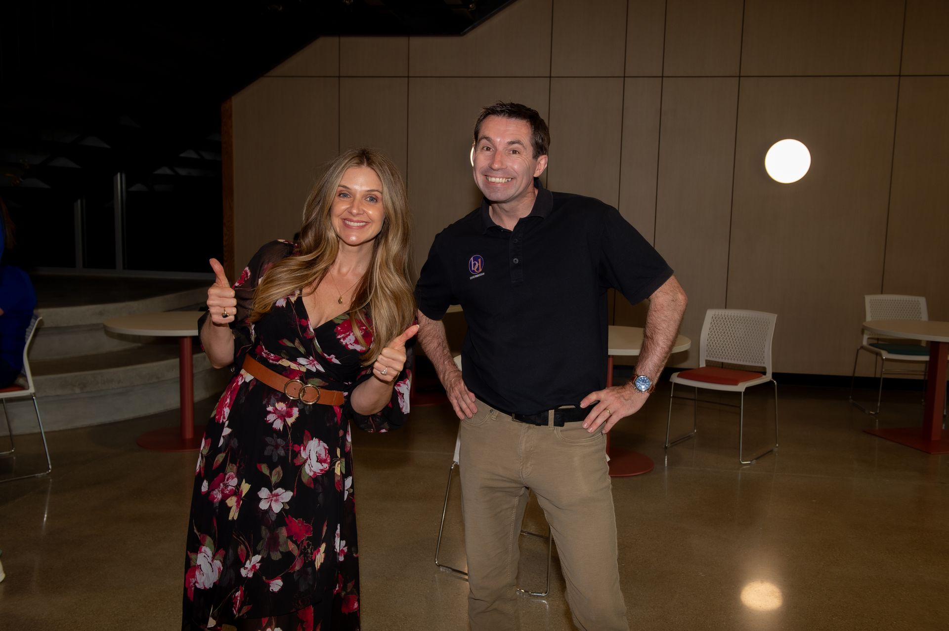 A man and a woman are standing next to each other in a room.