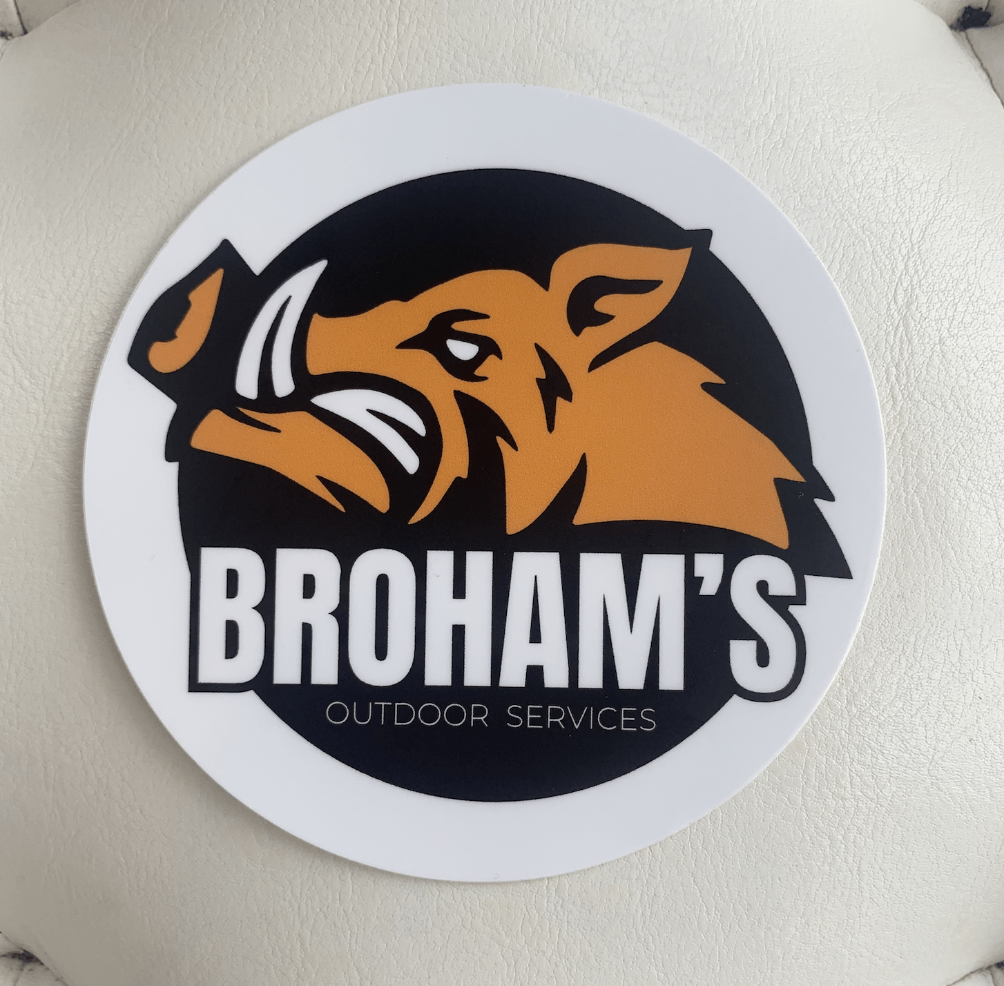 Round logo with a boar head and the text “BROHAM’S” and “OUTDOOR SERVICES” on a white background