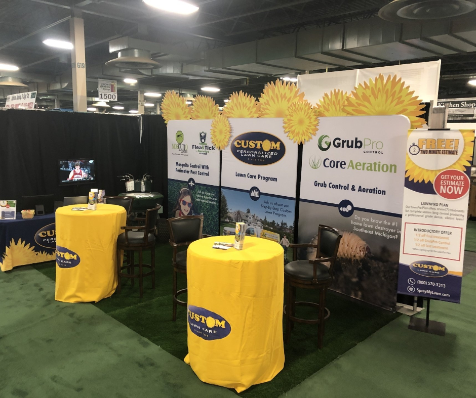 A booth with yellow tables and a sign that says g grubpro