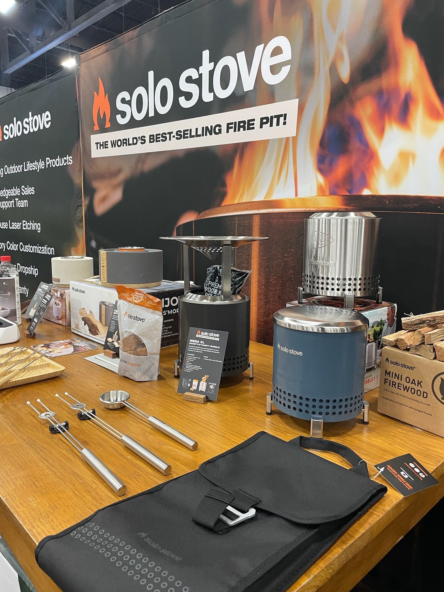 A table with a solo stove on it and a bag on it.