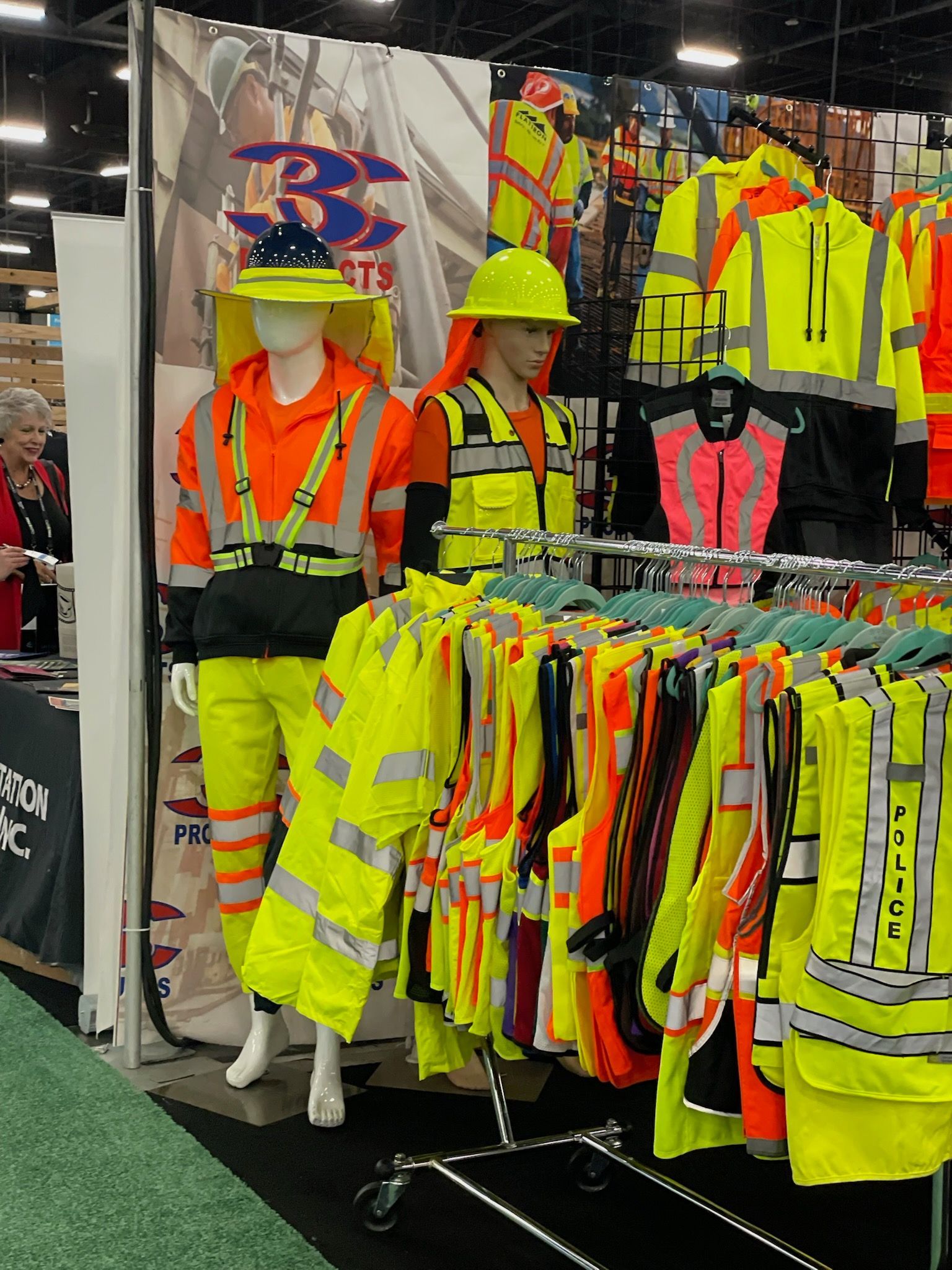A mannequin wearing a hard hat is standing in front of a display of safety gear.