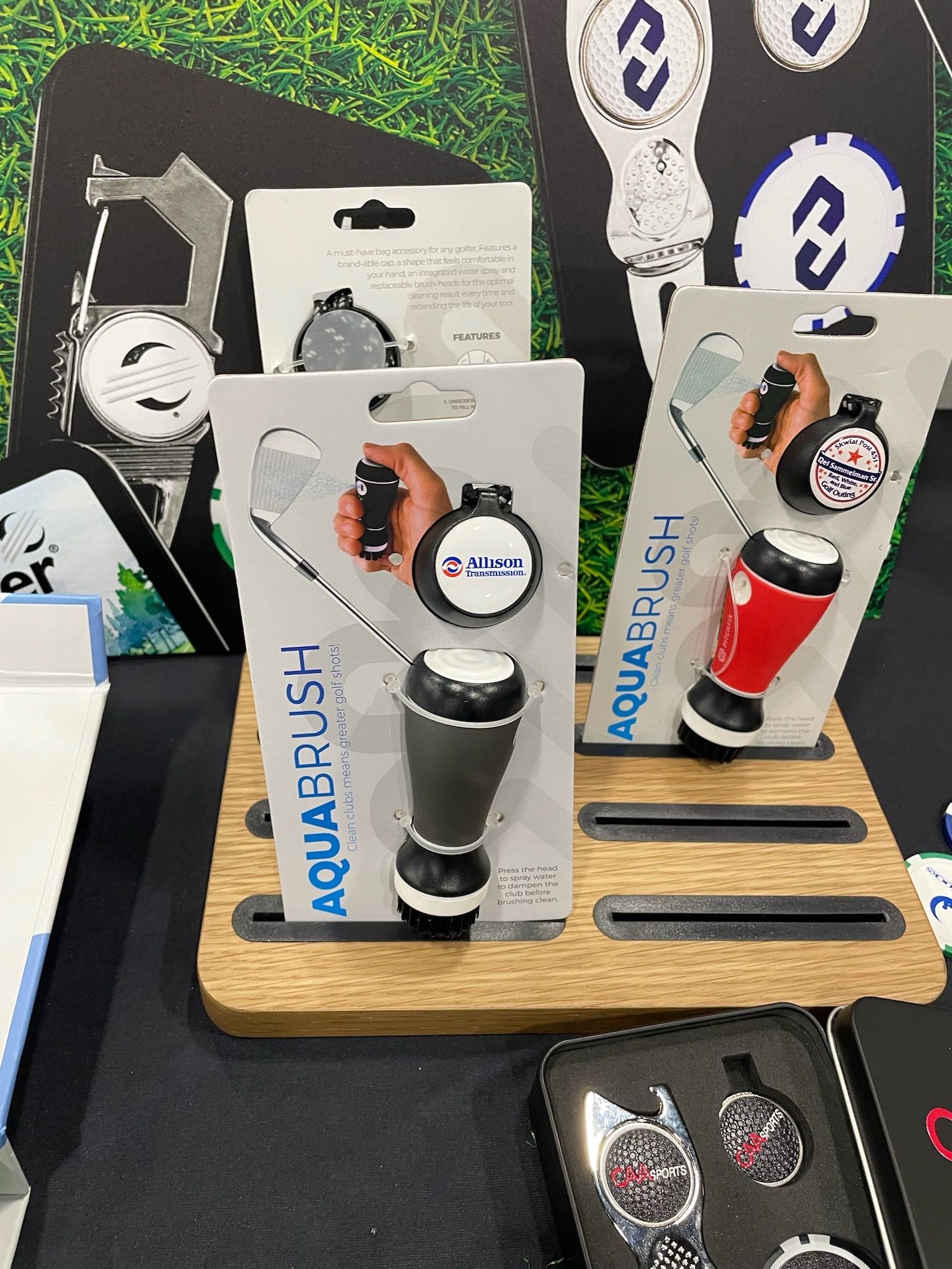 A display of aqua brush bottle openers on a wooden stand