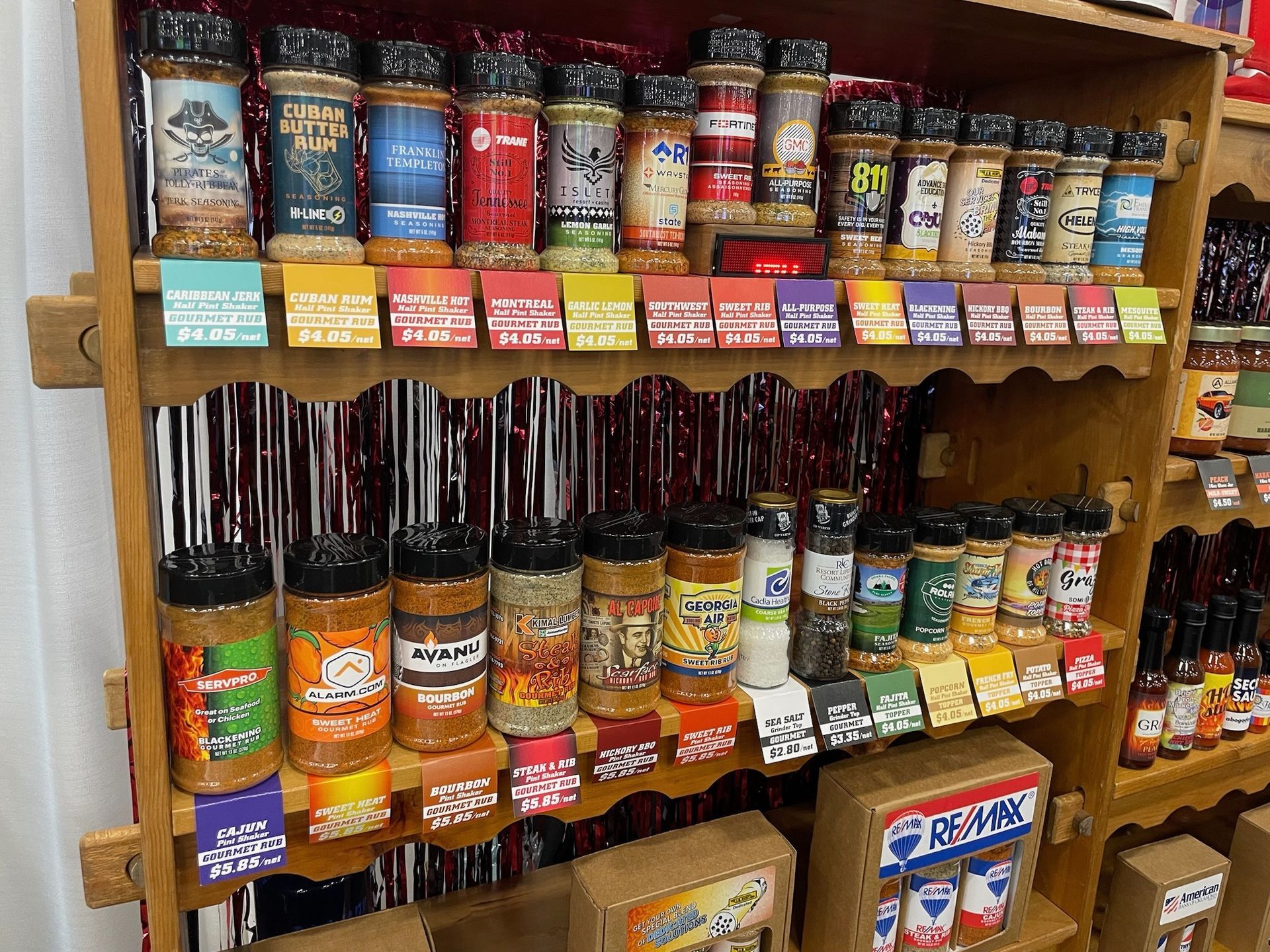 A shelf filled with a variety of spices and condiments.