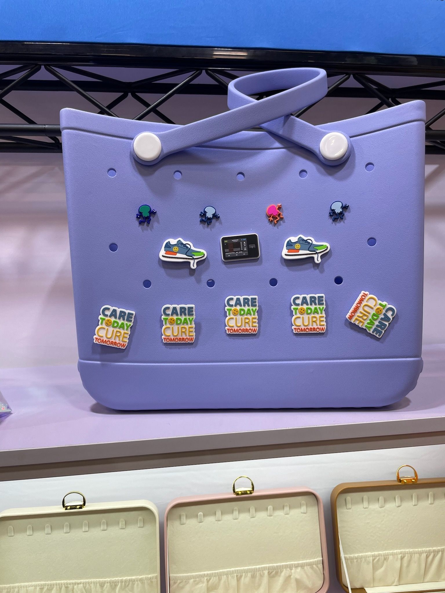 A purple bag with a lot of stickers on it