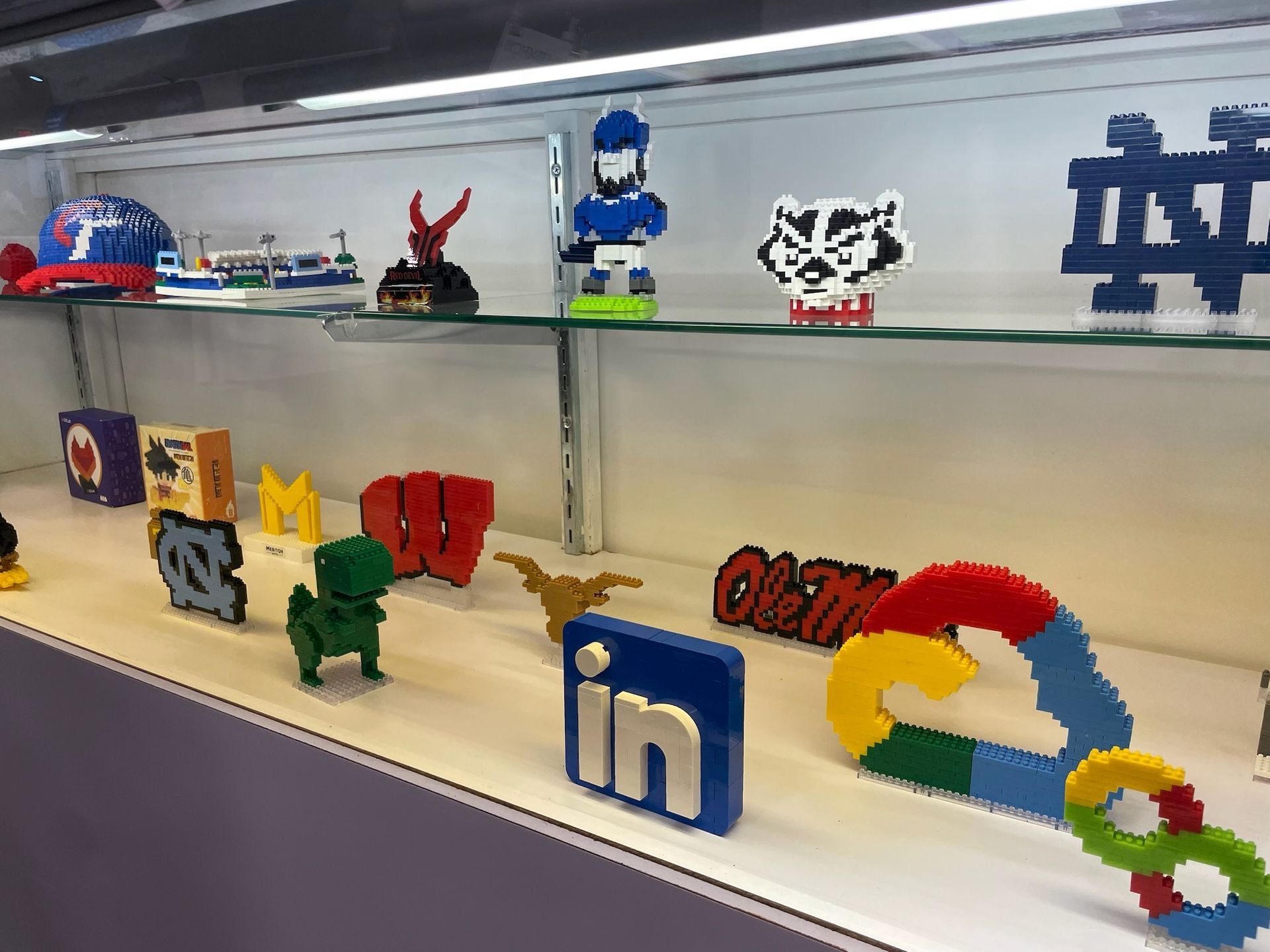 A display case with a bunch of lego toys on it