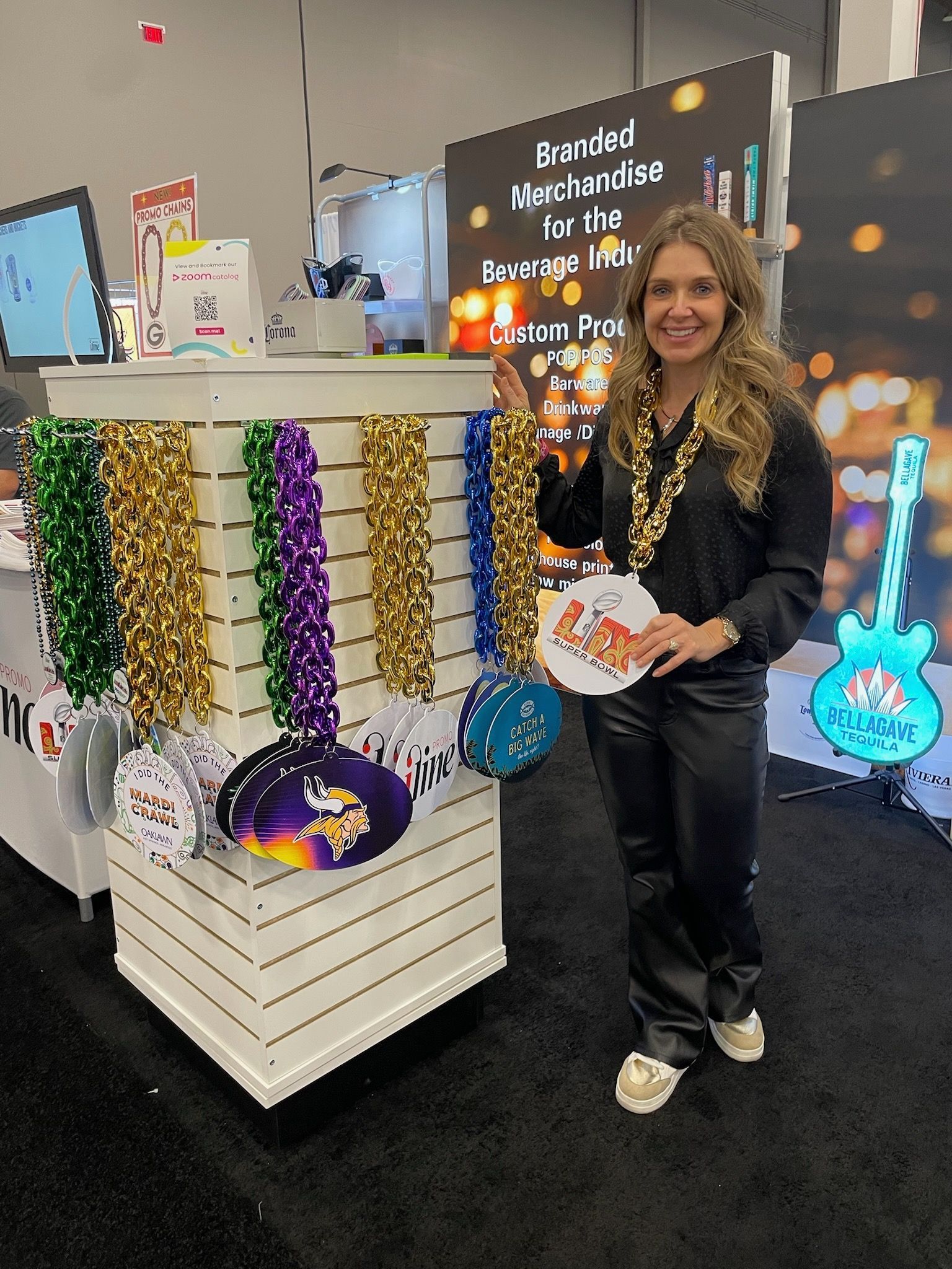 A woman is standing in front of a display of mardi gras decorations.