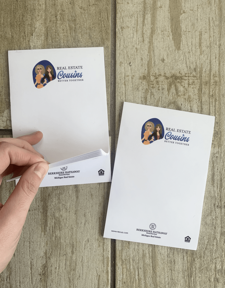 A person is holding a piece of paper with a picture of a woman on it.