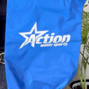 Blue bag with the white “Action Water Sports” logo.
