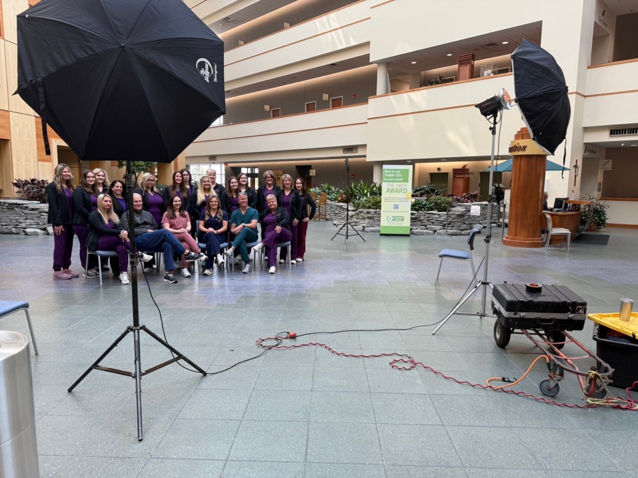 A group of people are posing for a picture in an atrium