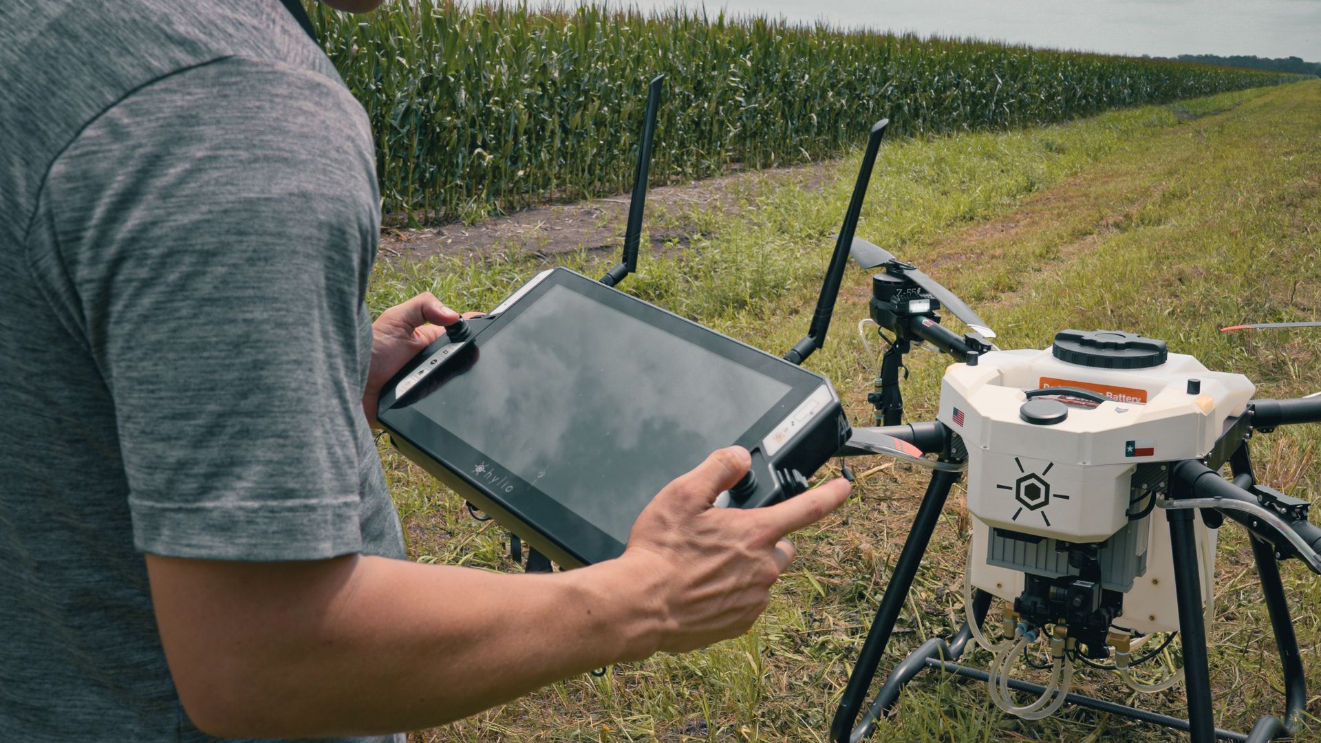 Man using GroundLink Remote to Control Hylio Drone