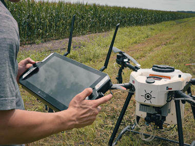 Man using GroundLink Remote  to Control Hylio Drone