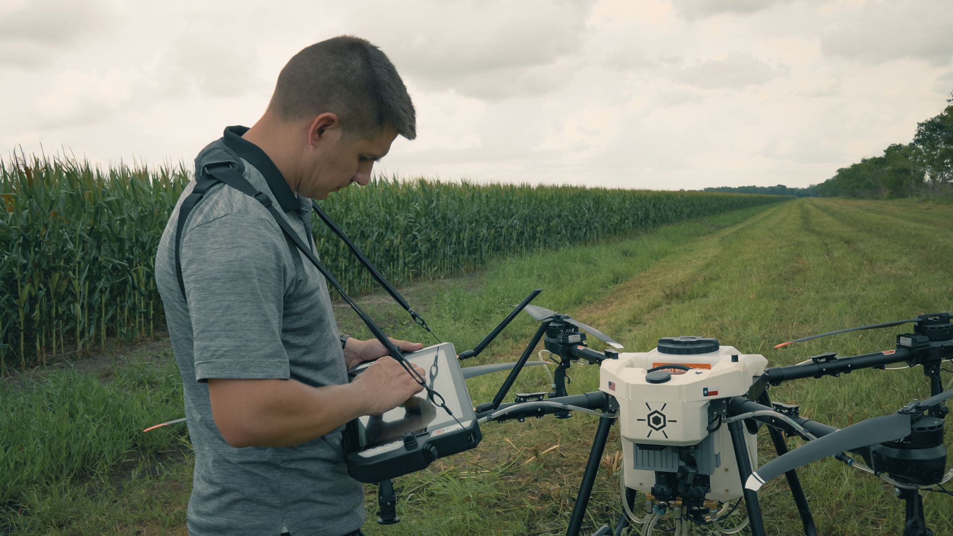 Man using GroundLink Remote to Control Hylio Drone