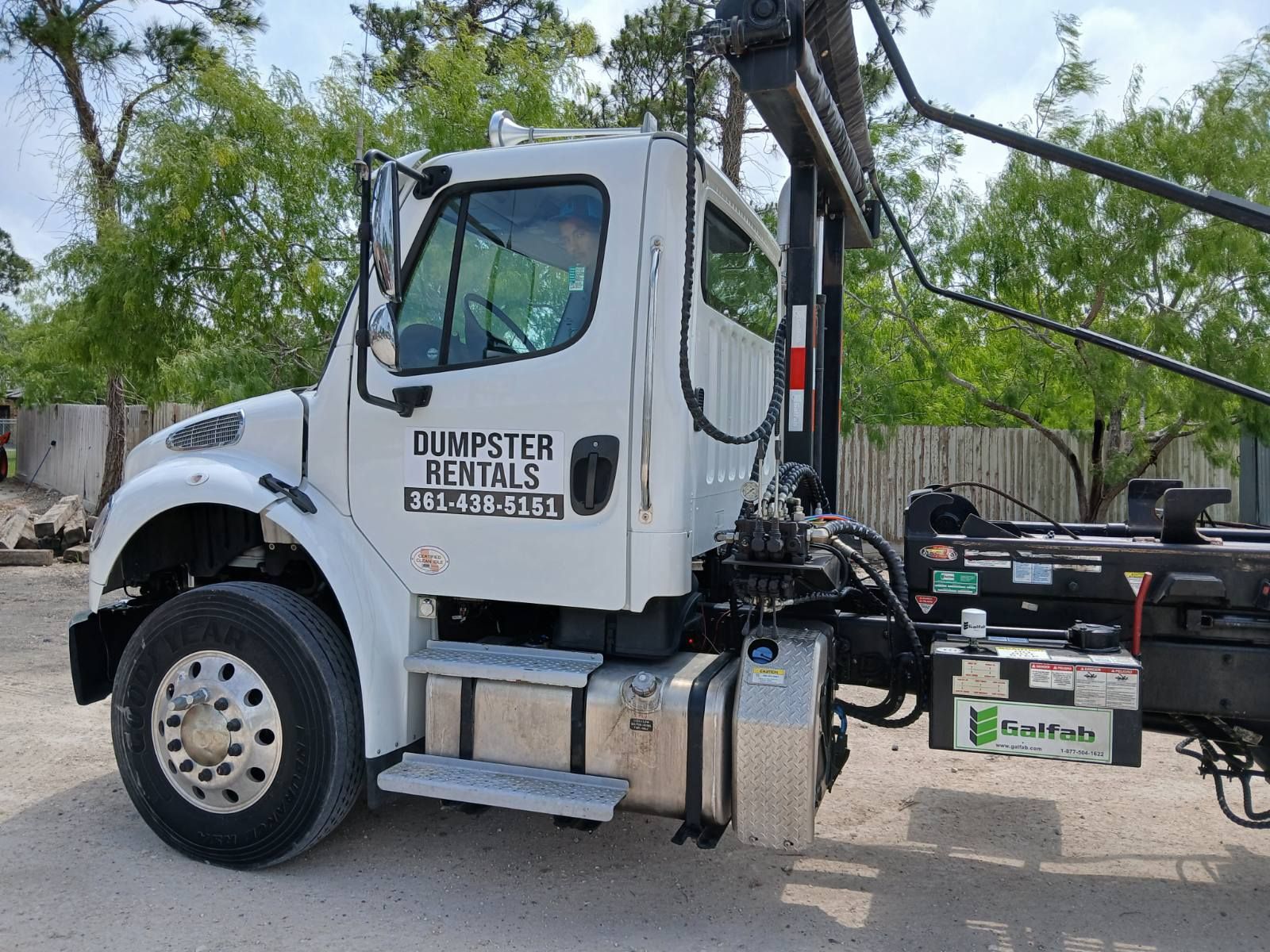 A Green Dumpster Filled With Bricks — Corpus Christi, TX — Dumpsters by Hebert Irrigation