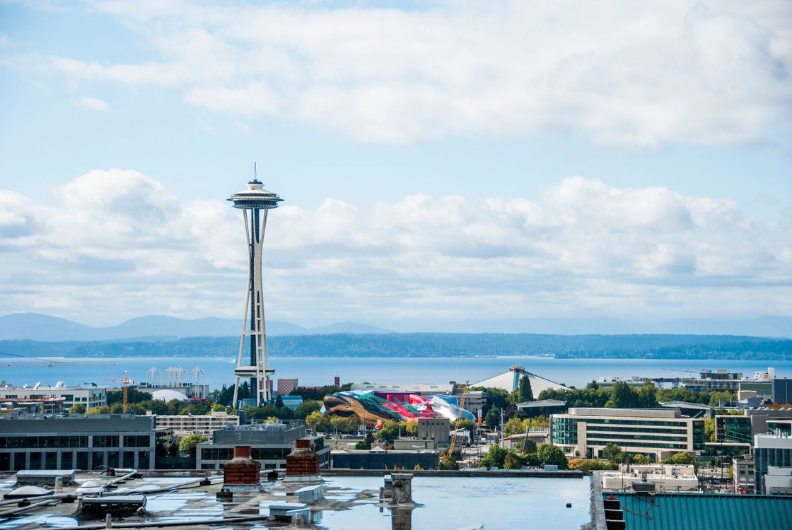 Seattle skyline with the Space Needle under a blue, partly cloudy sky