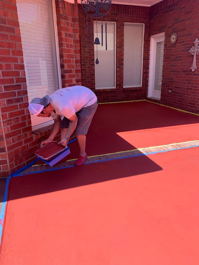 Garage with shiny orange floor, decorated with wall hangings and Budweiser banner.