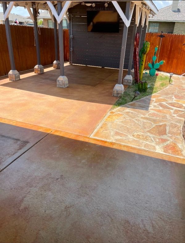 Patio with stamped concrete, pergola, and decorative cacti.