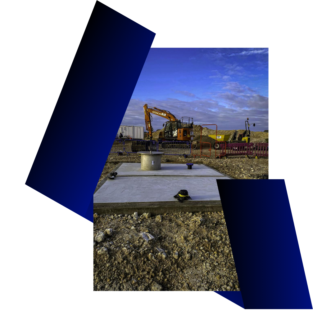 Construction site with machinery, concrete platform, and blue sky.