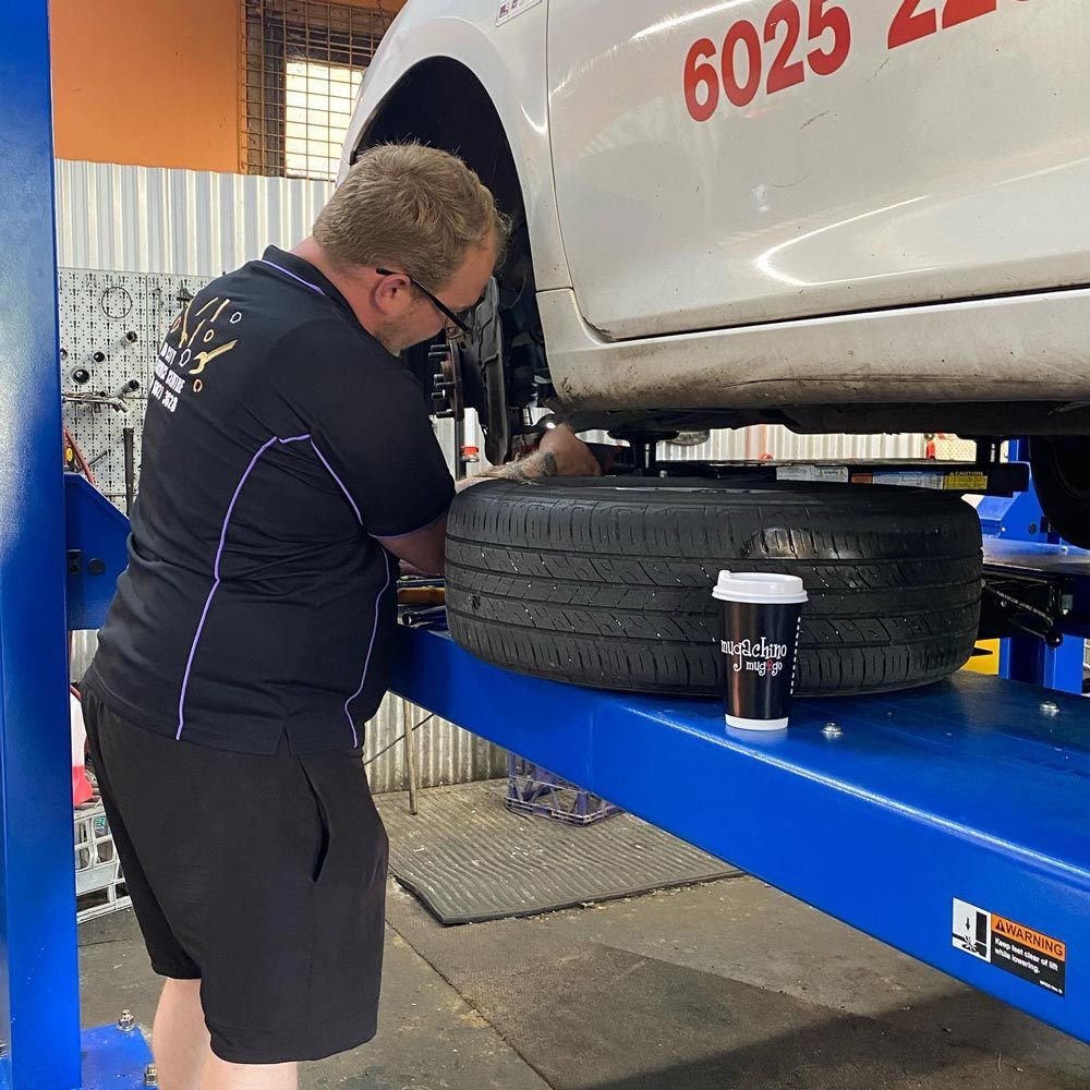 Mechanic replacing tyre — Licensed Mechanic in Albury, NSW
