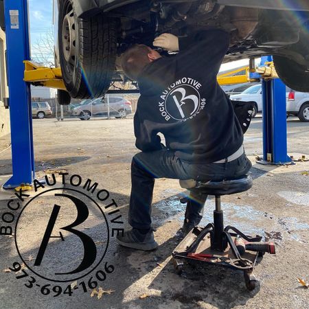 Bock Automotive mechanic working on car