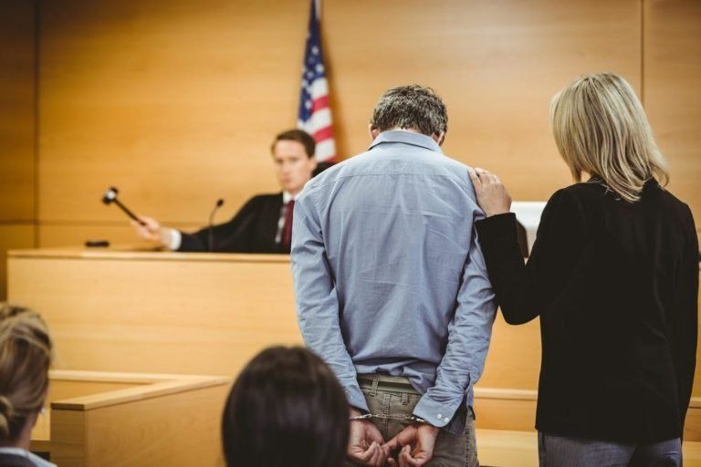 Man With Attorney In A Courthouse — St. Minneapolis, MN — Absolute Bail Bonds Man With Attorney In A Courthouse — St. Minneapolis, MN — Absolute Bail Bonds