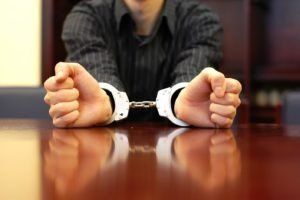 Man Showing Handcuffs — St. Minneapolis, MN — Absolute Bail Bonds Man Showing Handcuffs — St. Minneapolis, MN — Absolute Bail Bonds