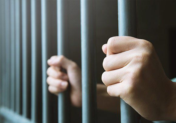 Hands Holding Cell Bars — St. Minneapolis, MN — Absolute Bail Bonds Hands Holding Cell Bars — St. Minneapolis, MN — Absolute Bail Bonds