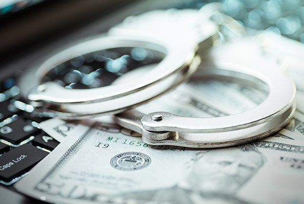 Handcuffs On Top Of Cash — St. Minneapolis, MN — Absolute Bail Bonds Handcuffs On Top Of Cash — St. Minneapolis, MN — Absolute Bail Bonds