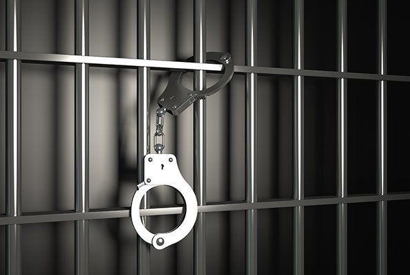 Handcuffs Attached On Jail Cell — St. Minneapolis, MN — Absolute Bail Bonds Handcuffs Attached On Jail Cell — St. Minneapolis, MN — Absolute Bail Bonds