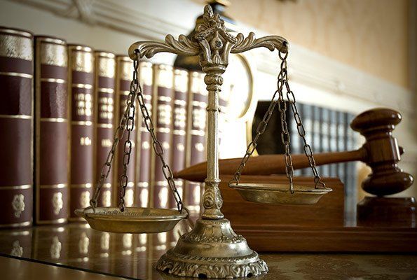 Justice Scale Infront Of Law Books  — St. Minneapolis, MN — Absolute Bail Bonds
