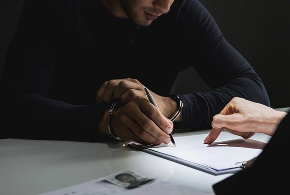Man Signing Form — St. Minneapolis, MN — Absolute Bail Bonds Man Signing Form — St. Minneapolis, MN — Absolute Bail Bonds