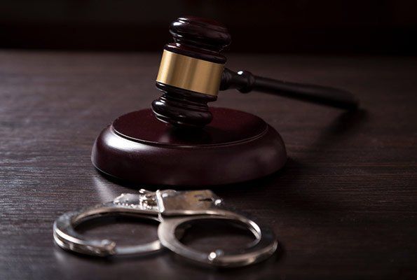 Gavel & Handcuffs On A Wooden Table  — St. Minneapolis, MN — Absolute Bail Bonds