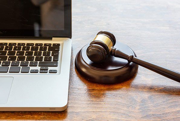 Gavel Near Laptop — St. Minneapolis, MN — Absolute Bail Bonds