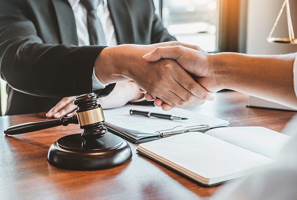 Shaking Hands With An Attorney — St. Minneapolis, MN — Absolute Bail Bonds Shaking Hands With An Attorney — St. Minneapolis, MN — Absolute Bail Bonds