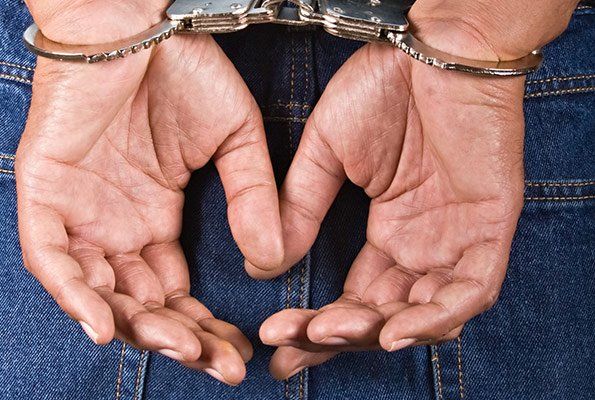 Close Up Of Man Hands In A Handcuff — St. Minneapolis, MN — Absolute Bail Bonds Close Up Of Man Hands In A Handcuff — St. Minneapolis, MN — Absolute Bail Bonds