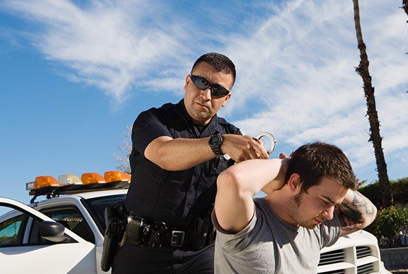 Man On His Knees Getting Arrested — St. Minneapolis, MN — Absolute Bail Bonds Man On His Knees Getting Arrested — St. Minneapolis, MN — Absolute Bail Bonds