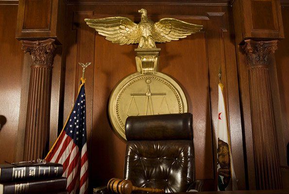 Justice Symbol Behind Chair — St. Minneapolis, MN — Absolute Bail Bonds Justice Symbol Behind Chair — St. Minneapolis, MN — Absolute Bail Bonds