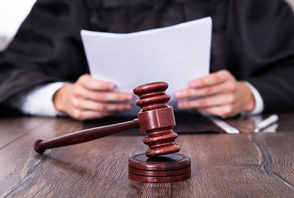 Judge Holding Papers — St. Minneapolis, MN — Absolute Bail Bonds Judge Holding Papers — St. Minneapolis, MN — Absolute Bail Bonds