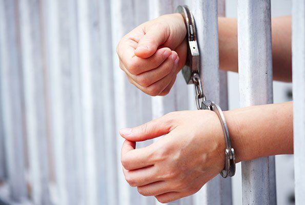 Hands With Handcuff Inside Jail — St. Minneapolis, MN — Absolute Bail Bonds Hands With Handcuff Inside Jail — St. Minneapolis, MN — Absolute Bail Bonds