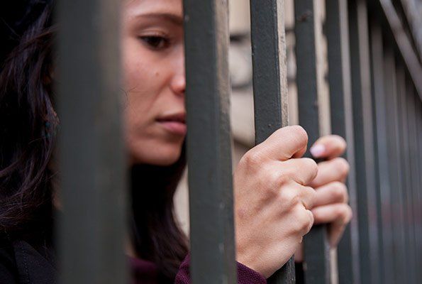 Woman Inside Cell Bar — St. Minneapolis, MN — Absolute Bail Bonds Woman Inside Cell Bar — St. Minneapolis, MN — Absolute Bail Bonds