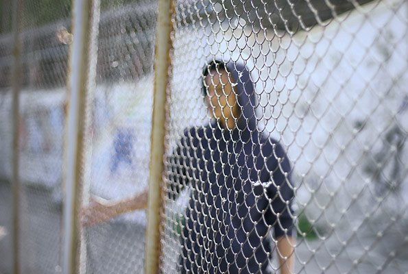 Man On Other Side Of Fence — St. Minneapolis, MN — Absolute Bail Bonds Man On Other Side Of Fence — St. Minneapolis, MN — Absolute Bail Bonds