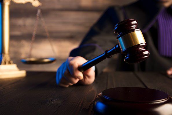 Judge Holding Wooden Gavel — St. Minneapolis, MN — Absolute Bail Bonds Judge Holding Wooden Gavel — St. Minneapolis, MN — Absolute Bail Bonds