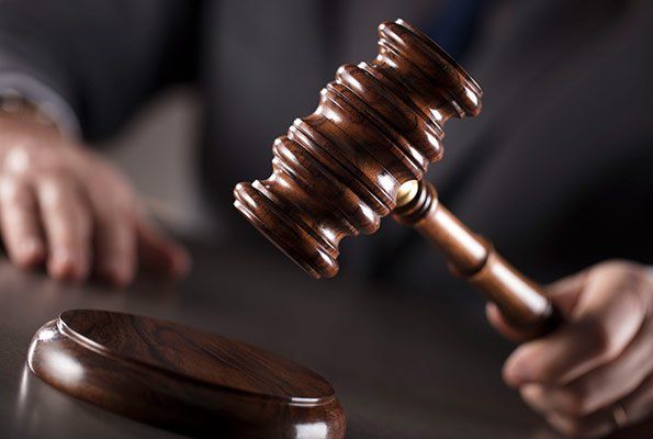 Man Holding Gavel — St. Minneapolis, MN — Absolute Bail Bonds Man Holding Gavel — St. Minneapolis, MN — Absolute Bail Bonds