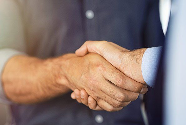Two Men Shaking Hands — St. Minneapolis, MN — Absolute Bail Bonds Two Men Shaking Hands — St. Minneapolis, MN — Absolute Bail Bonds